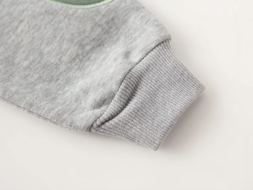 Close-up of Round Neck Sweatshirt with Contrasting Sleeves - SF3550 showing ribbed cuff detail on gray fabric.